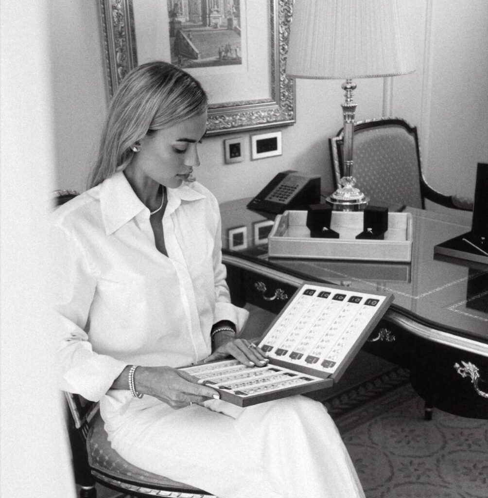 Founder in a white shirt reviewing a tray of certified diamonds at an antique desk