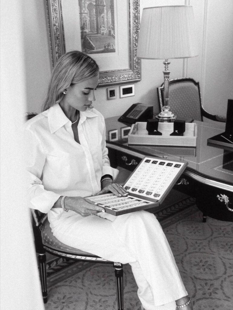 Founder in a white shirt reviewing a tray of certified diamonds at an antique desk