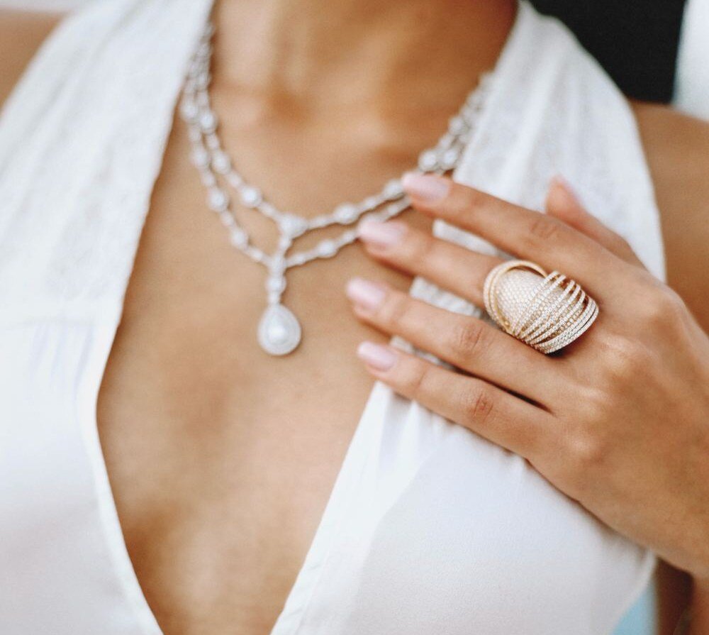 Layered diamond necklace with pendant and a pavé cocktail ring