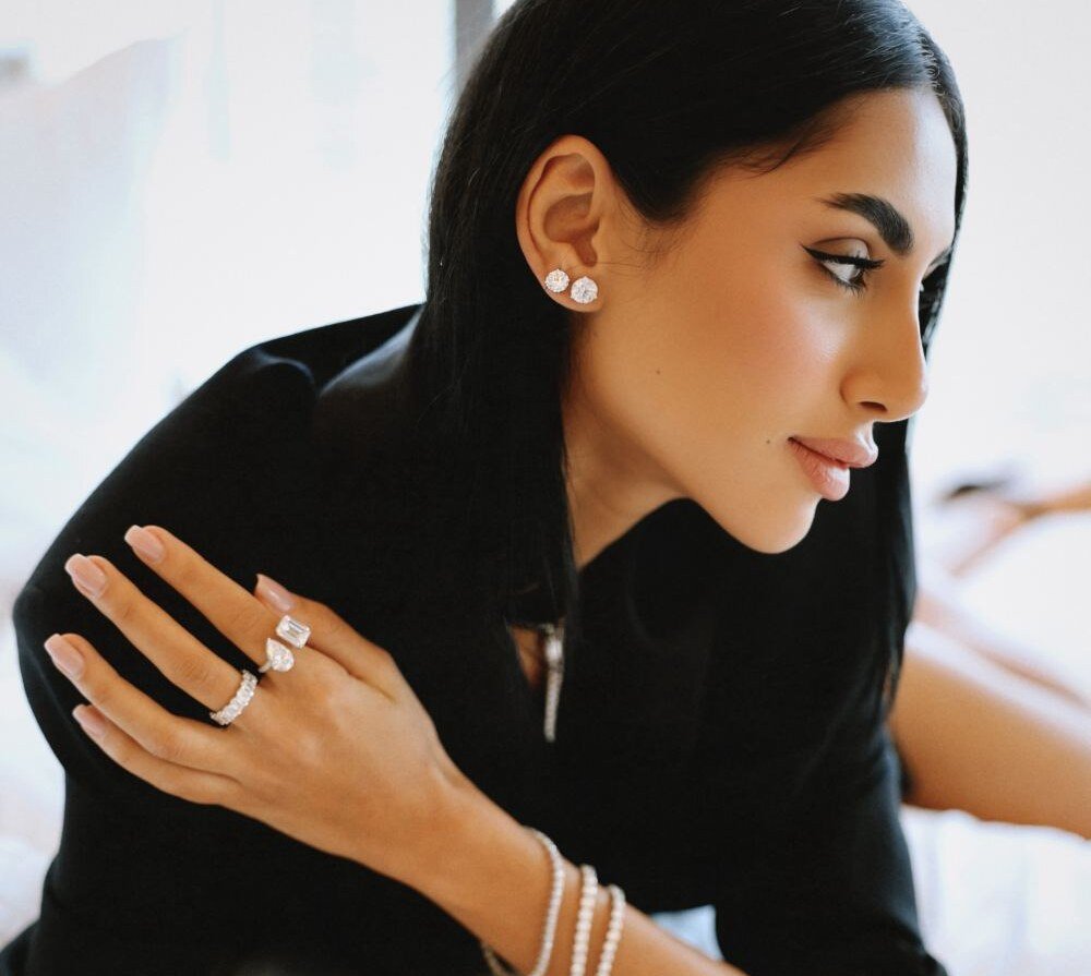 Diamond studs, rings and bracelets worn leaning on a bed