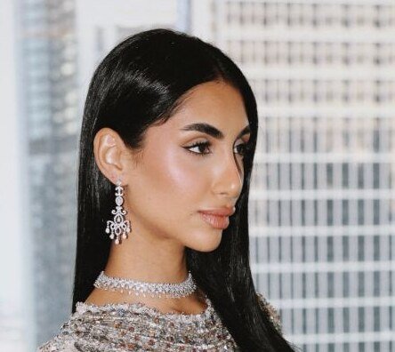 Close profile portrait with diamond chandelier earrings and choker